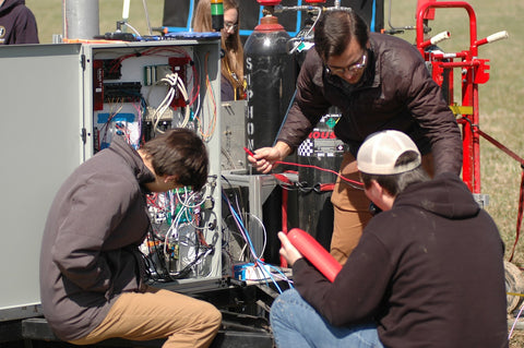 Akronauts team members configuring test stand